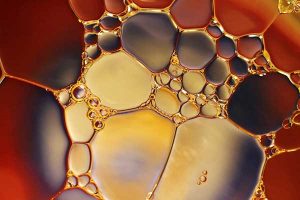 Macro close-up of oil - read how polyalkylene glycols (PAGs) can reduce ester vulnerability to hydrolysis in the Prospector Knowledge Center.