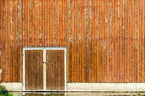 Image of weathered barn and doors - learn how to evaluate coating testing in the Prospector Knowledge Center.