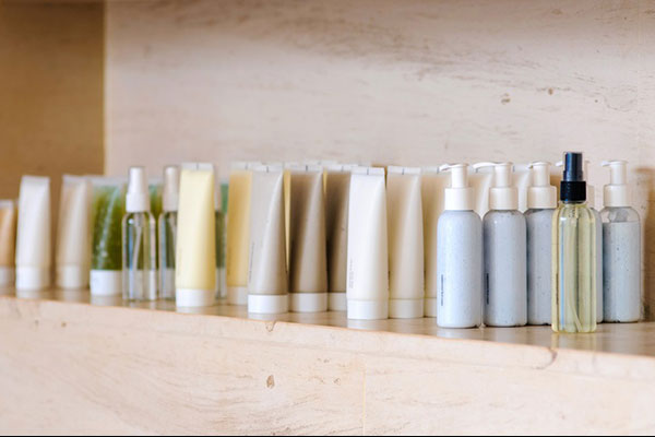 Group of variable skin care container products from natural ingredients on marble shelf - Learn about fatty alcohols in personal care products
