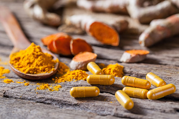 photo of turmeric in powder and pill form - learn more about the benefits of turmeric