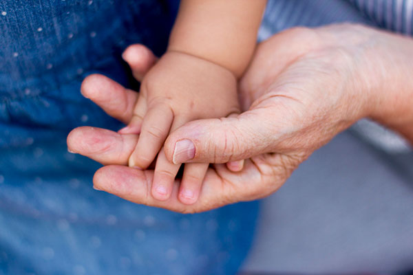 elderly person holding a baby's hand - Learn about free radicals and quench technology