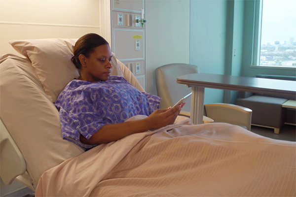 Woman in hospital bed - - Learn how copper can help combat infections