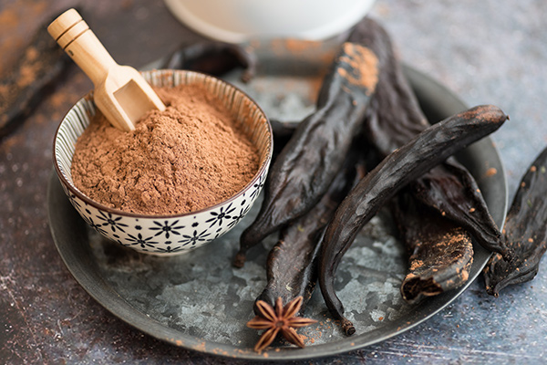 Photo of carob in plant and powder form - Why should you care about carob?