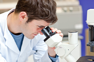 Man looking into microscope