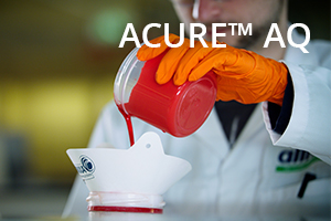 ACURE AQ Lab worker pouring red liquid