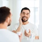 Young man applying face lotion - learn how prebiotic and probiotic materials can be use in skin care formulations in the Prospector Knowledge Center.