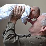 Grandfather holding baby - learn about nutritional needs of older adults in the Prospector Knowledge Center.
