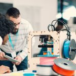 photo of people using a 3D printer - learn more about 3D printing materials