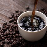 Photo of coffee cup and coffee beans - Coffee Industry Trends: Breaking Out of the Daily Grind