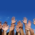 Photo of many hands in the air - Learn more about multi-ethnic skincare
