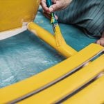 woman painting a chair with yellow paint - Structure and Behavior of Wetting Agents