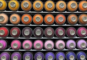 Stack of colorful air spray paint cans